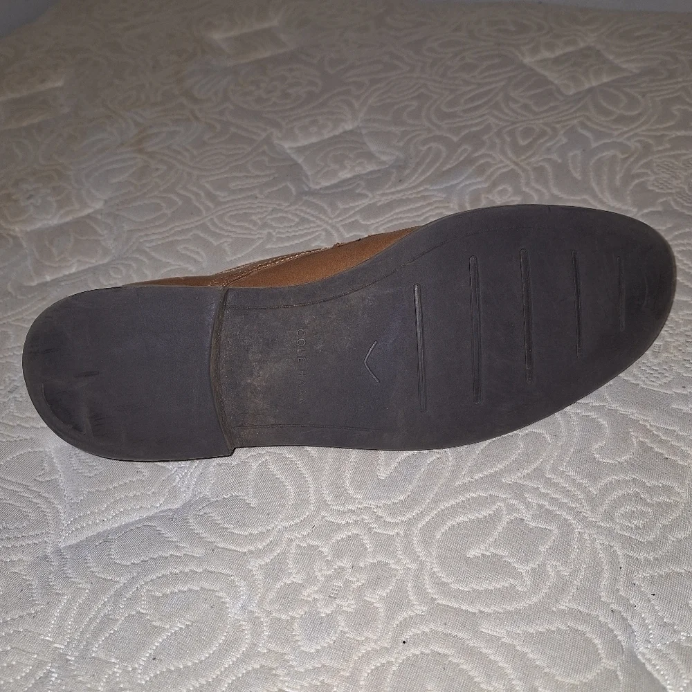 A pair of Cole Haan Oxfords in a men's size 12M. Pre-loved in good condition.